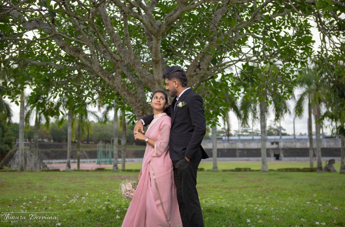 Couple beneath a frangipani tree