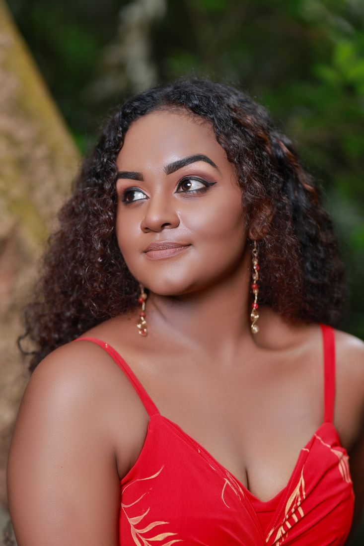 Smiling portrait in a red dress with beaded earrings